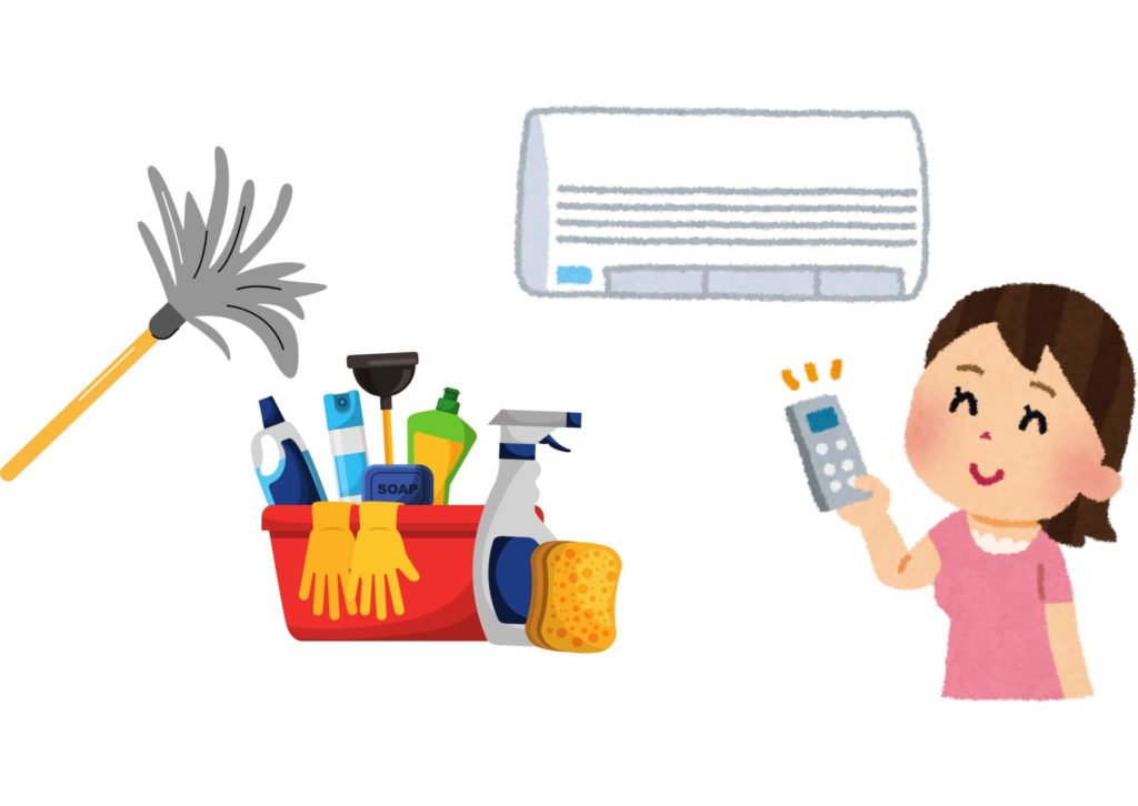 お掃除道具と笑顔でエアコンの電源を入れている主婦